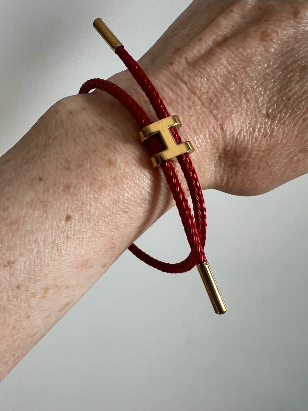 Red Cord Bracelet with Gold H Hardware Accent